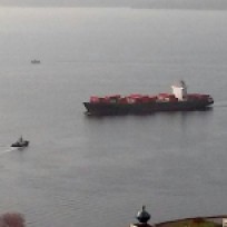 A tugboat meeting a large ship.